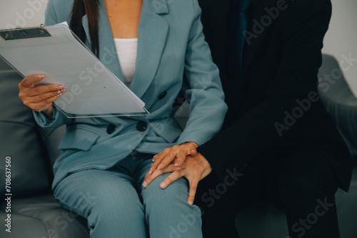 Sexsual harassment in workplace. Unhappy female employee looking at hand of boss touch at her shoulder and feeling disgusted.