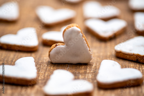 Heart-shaped cinnamon cookies, cookies with white cinnamon icing, arranged

 photo