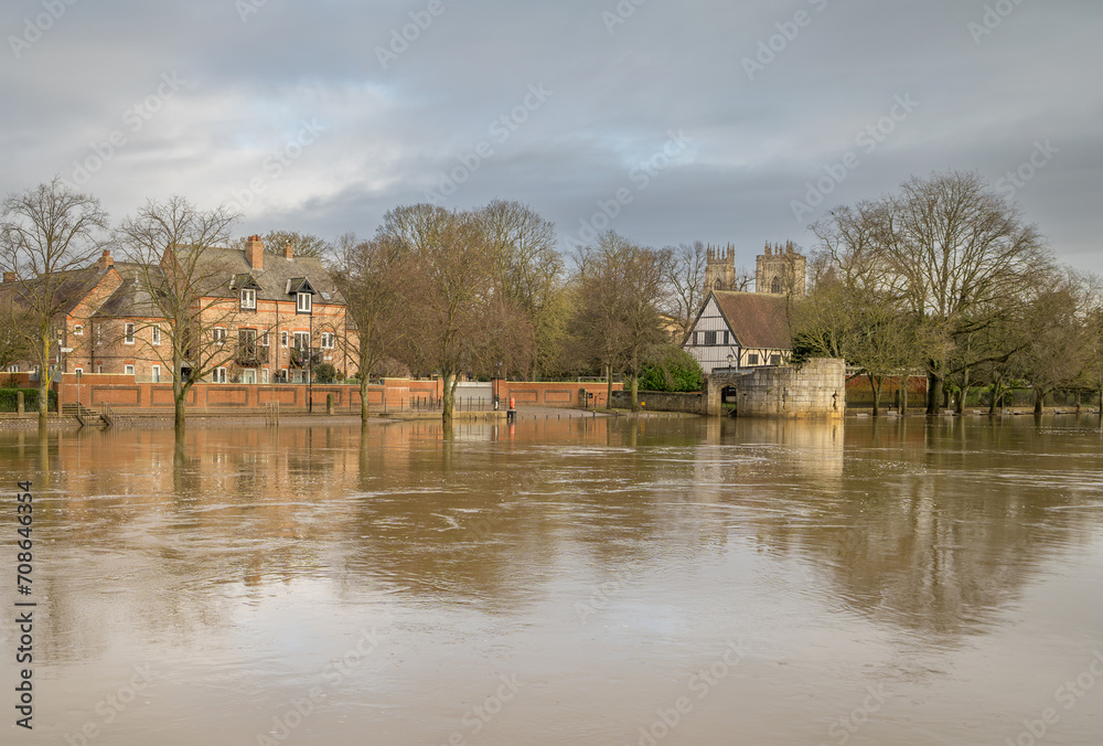 Obraz premium Looking from one bank to the opposite side, flooded River Ouse in York near the Museum Gardens