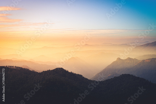 Witness the breathtaking beauty of nature as the sun sets behind the majestic mountain range. Embrace the serenity and tranquility of this picturesque landscape © Naveen
