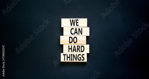 We can do hard things symbol. Concept words We can do hard things on wooden blocks. Beautiful black table black background. Business, we can do hard things concept. Copy space.