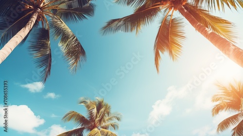 Palm trees on tropical beach, coconut trees. Tropical trees with sunlight in the sky, sunset and clouds abstract background. Vintage tone filter effect color style.