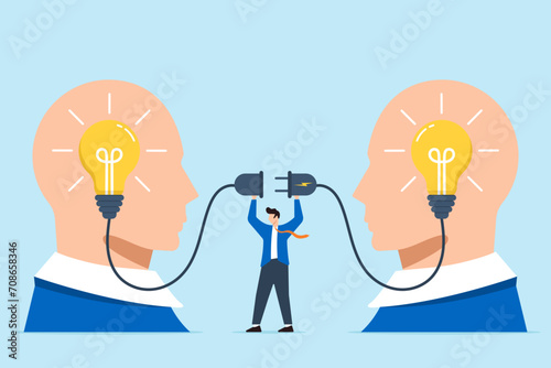 Businessman connecting bright lightbulb on human head