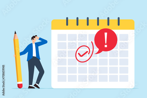 Businessman marks important day on calendar with red circle photo