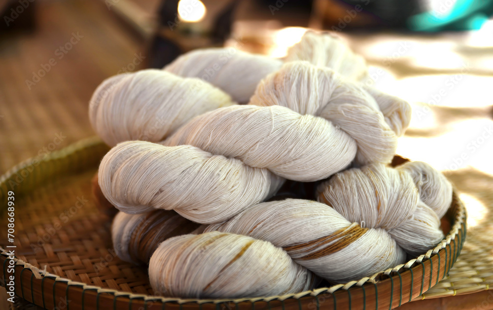 Close up image of tie a yarn of cotton in round threshing bamboo basket. Raw materials prepared for dyeing and weaving into cotton fabric