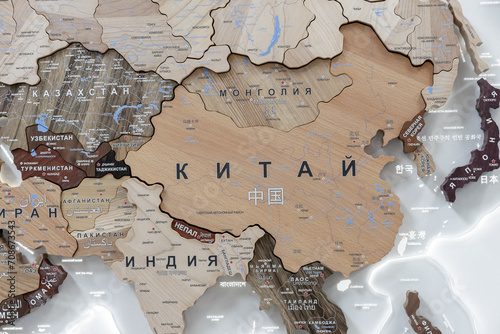 Wooden map of China and neighboring countries, names of countries in Russian. Map for trip planning.