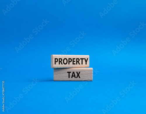 Property Tax symbol. Concept word Property Tax on wooden blocks. Beautiful blue background. Business and Property Tax concept. Copy space