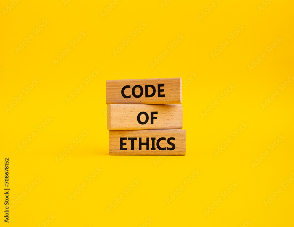 Code of ethics symbol. Concept words Code of ethics on wooden blocks. Beautiful yellow background. Business and Code of ethics concept. Copy space. Code of ethics symbol. Concept words Code of ethics on wooden blocks. Beautiful yellow background. Business and Code of ethics concept. Copy space.