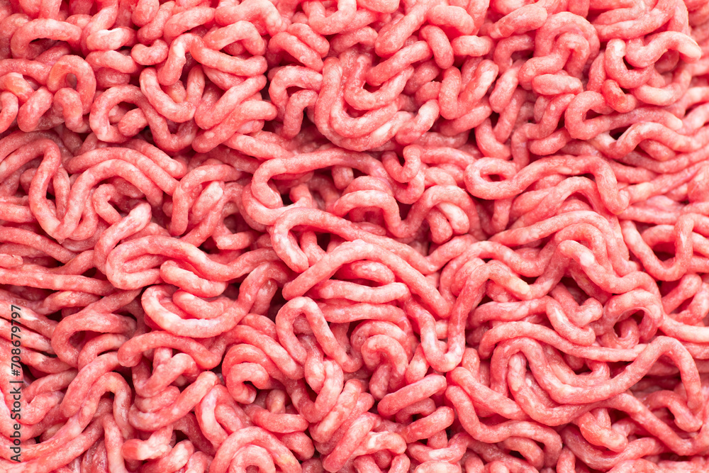 Minced meat, beef mince, forcemeat, fresh raw uncooked ground meat texture, close up, food background. Flat lay, top view Minced meat, beef mince, forcemeat, fresh raw uncooked ground meat texture, close up, food background. Flat lay, top view