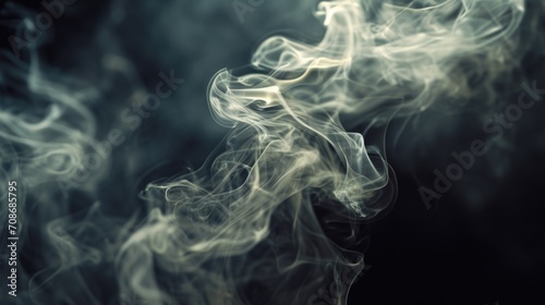 Smoke captured in a close-up shot against a black background. Ideal for creating a mysterious and dramatic atmosphere in various projects