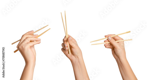 A set of female hands holding wooden chopsticks for sushi or rolls on a blank background. photo