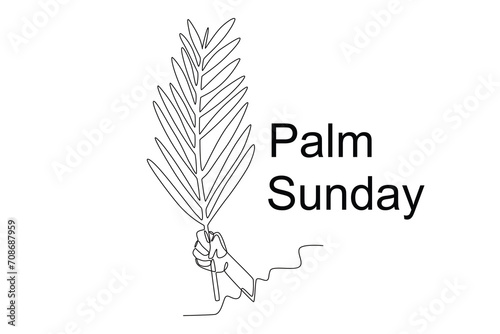 A person's hand holds a palm leaf