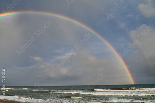 Cloudy sky with a double rainbow over the ocean at the beach - Topsail Island NC