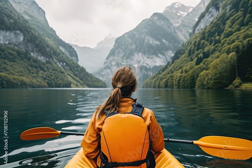 Model enjoying a serene kayak trip on a mountain lake
