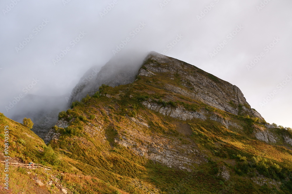 Mountain peak in fog, fog shrouded a mountain peak, natural landscape Mountain peak in fog, fog shrouded a mountain peak, natural landscape