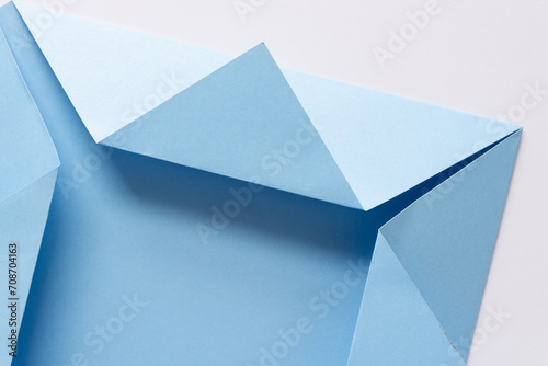 folded light blue crafting paper with triangle flaps on white