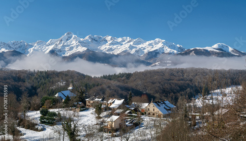 View of the snow-capped Pyrenees and village in winter in south-west France photo