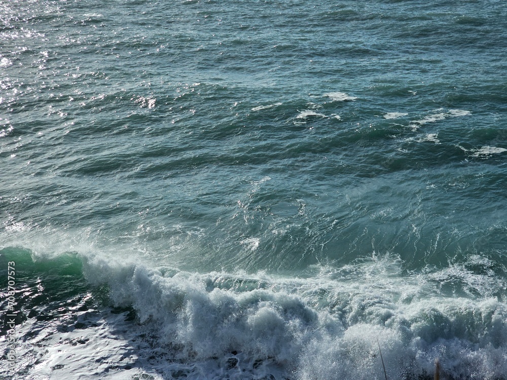 Corniglia, 5 Terre, Italy - January 05, 2024: Beautiful photography of the Cinque Terre landscape. Spectacular  view of the waves with blue sky in the background in winter days. 