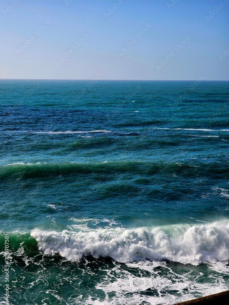 Fototapeta premium Corniglia, 5 Terre, Italy - January 05, 2024: Beautiful photography of the Cinque Terre landscape. Spectacular view of the waves with blue sky in the background in winter days.