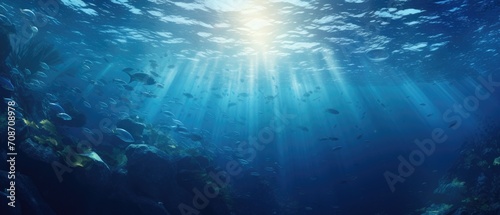 Sunlight piercing through marine depths with tropical fish. Underwater world. © Postproduction