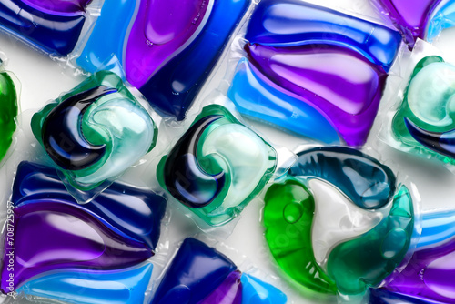 Washing capsules, colorful laundry pods. Colorful Soluble capsules with laundry gel detergent and dishwasher soap. Pile of various washing pod capsules. Detergent tablets. Top View, Flat Lay 