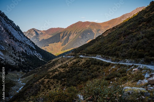 Landscape of the mountains, sky, forest and trail in autumn. Liddes, Valais Canton, Switzerland.