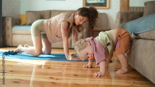 mother and toddler kid doing stretching exercises training together cozy home. Funny asian family young healthy mom teaching cute little kid daughter meditate together sit floor, japanese mother child photo