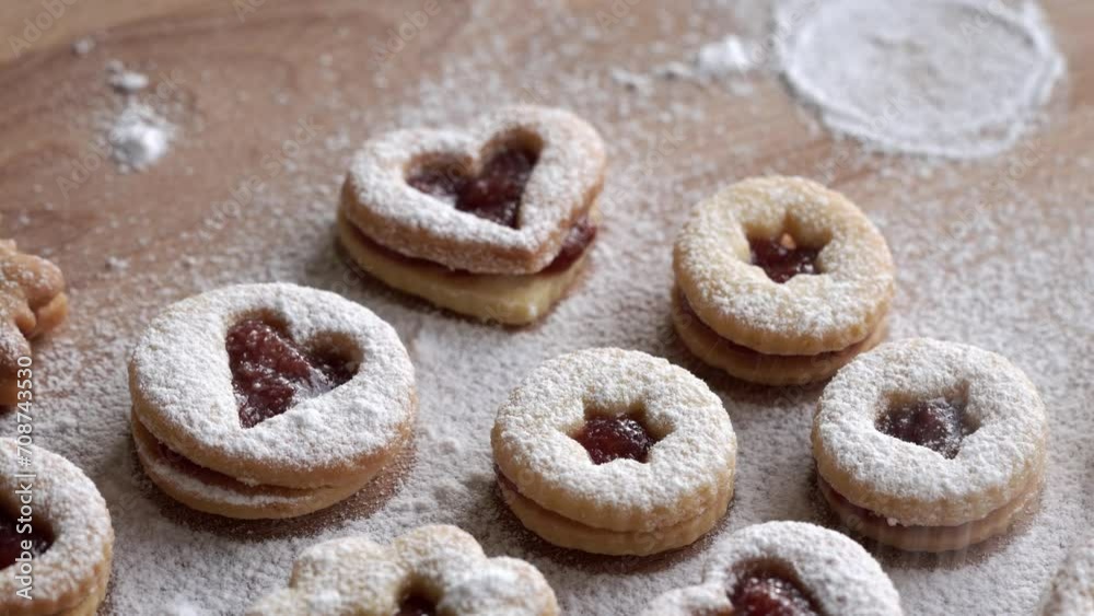 Dusting Linzer Christmas cookies with sugar, closeup