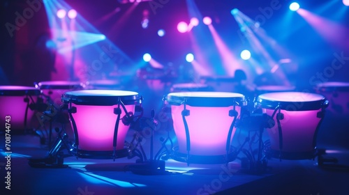 Conga drums illuminated by neon colorful stage lights. Can be used for musical event promotions or articles about live performances. Traditional percussion musical instrument of Afro-Cuban. photo