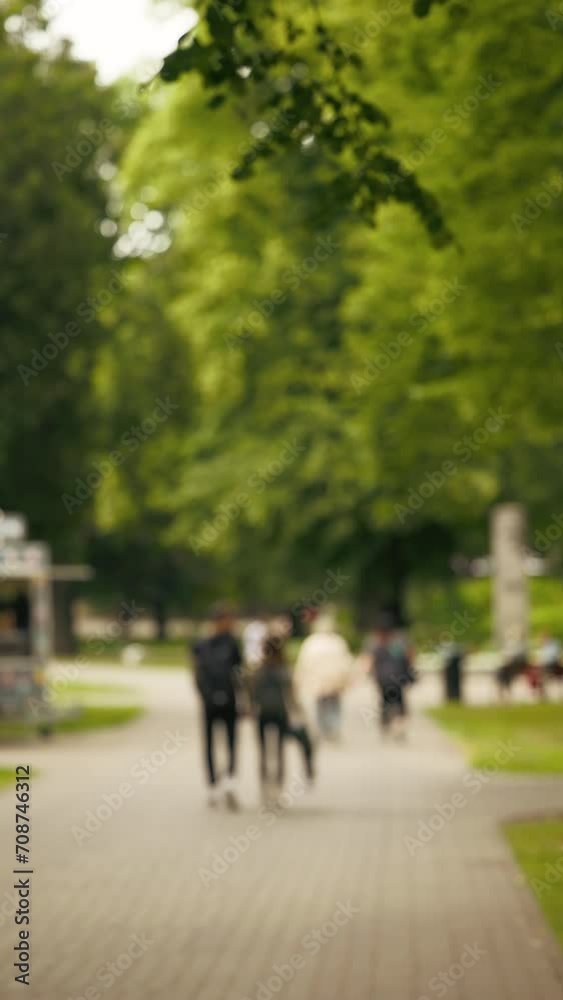 Exceptional visuals unfold with an establishing defocused shot of summer city streets in vertical format Exceptional visuals unfold with an establishing defocused shot of summer city streets in vertical format