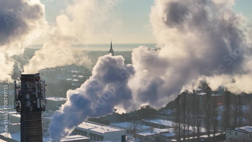 Smoke plumes and church visible in the distance 