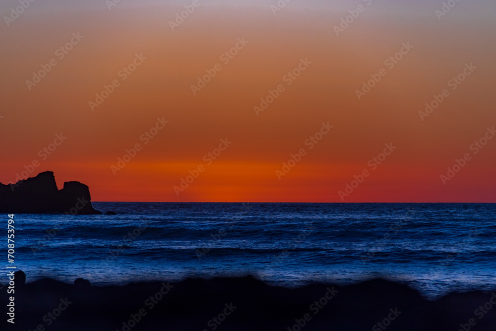 Sunset at Piha, West Auckland, Auckland region of New Zealand. January 12, 2024 -