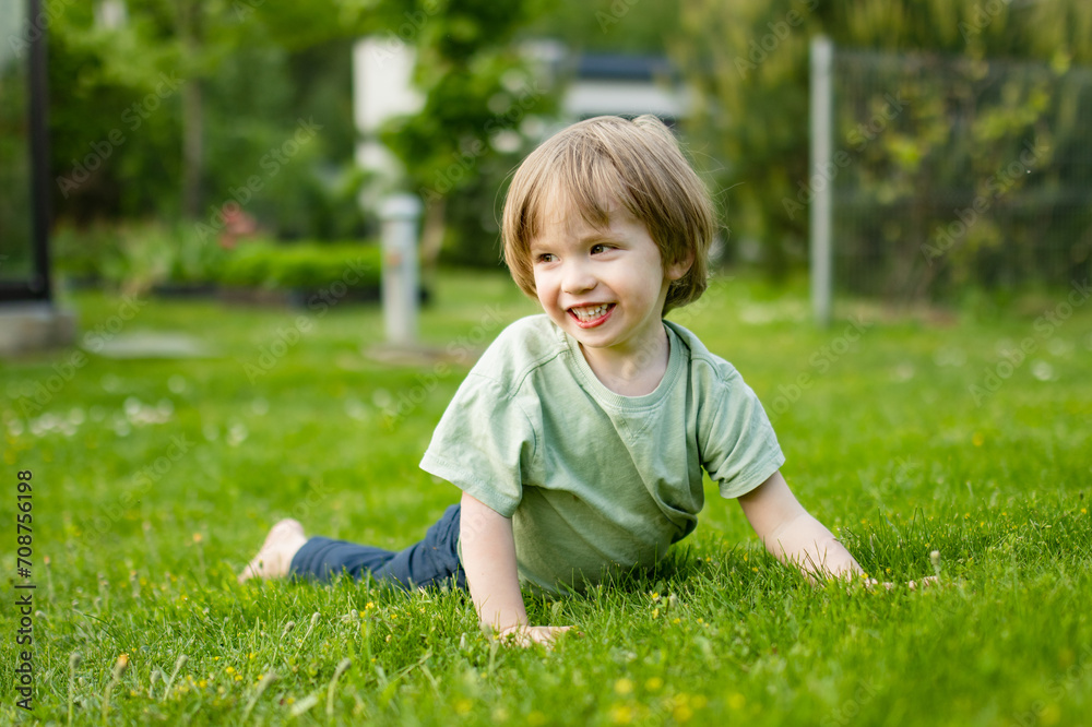 Cute toddler boy playing outdoors on sunny spring day. Child exploring nature. Cute toddler boy playing outdoors on sunny spring day. Child exploring nature.