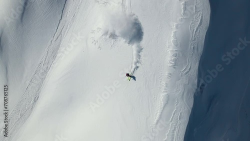 Drone view of a skier descending a steep slope. Freeride