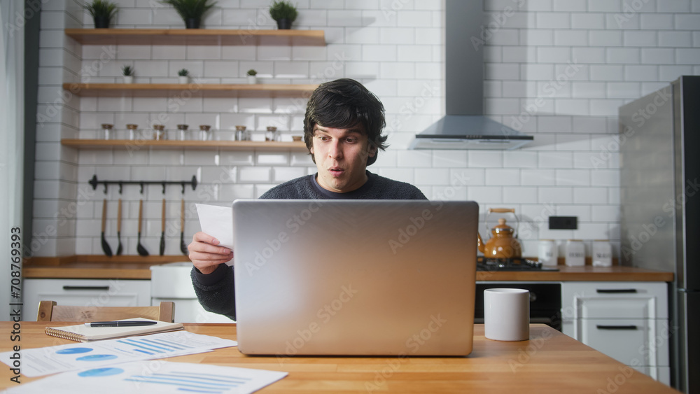 Surprised university student sitting in the kitchen at home, looking laptop computer, studying, taking notes. Male student researching, study at home.
Surprised university student sitting in the kitchen at home, looking laptop computer, studying, taking notes. Male student researching, study at home.