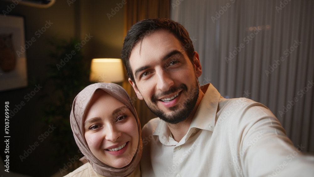 Close up married happy couple standing husband holds the cellphone in his hand remote video call conversation with friends or family
Close up married happy couple standing husband holds the cellphone in his hand remote video call conversation with friends or family
