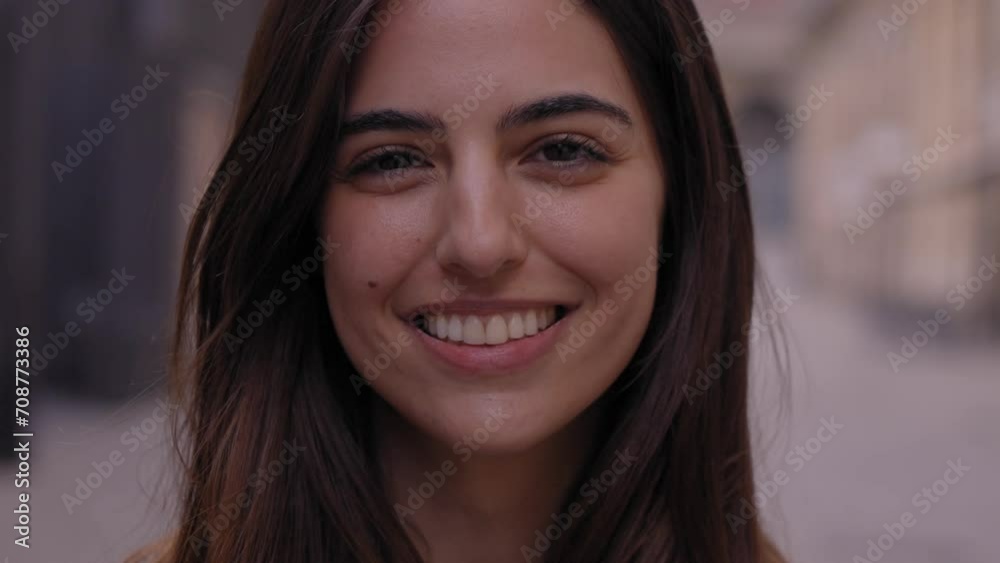 Close up portrait joyful beautiful young Caucasian gen z woman happy smiling on city street. Female people with nice expression looking at camera in open air. Spanish girl posing for picture outdoor Close up portrait joyful beautiful young Caucasian gen z woman happy smiling on city street. Female people with nice expression looking at camera in open air. Spanish girl posing for picture outdoor