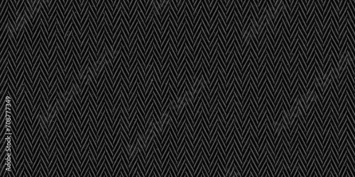 Seamless dark black and grey herringbone tweed textile texture background. Closeup of realistic tileable mottled distressed woolen striped zigzag fabric pattern. High resolution 3D rendering backdrop. photo