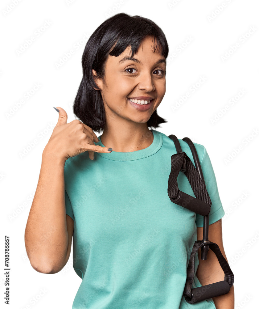 Young Hispanic athlete with resistance bands showing a mobile phone call gesture with fingers. Young Hispanic athlete with resistance bands showing a mobile phone call gesture with fingers.
