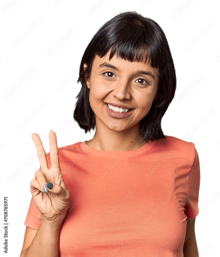 Young Hispanic woman with short black hair in studio showing victory sign and smiling broadly. Young Hispanic woman with short black hair in studio showing victory sign and smiling broadly.