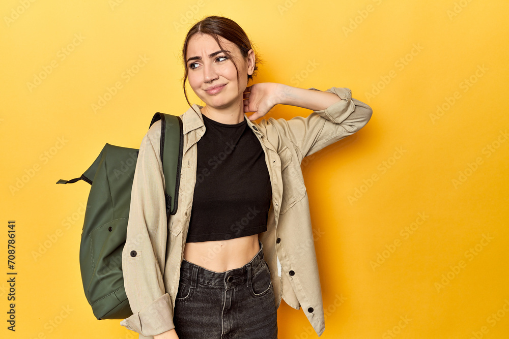 Young traveler woman with her backpack touching back of head, thinking and making a choice. Young traveler woman with her backpack touching back of head, thinking and making a choice.