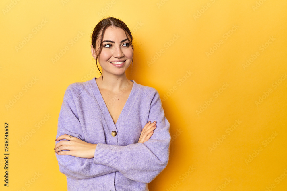 smiling confident with crossed arms.
