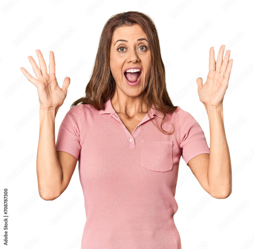 Middle-aged woman portrait in studio setting celebrating a victory or success, he is surprised and shocked. Middle-aged woman portrait in studio setting celebrating a victory or success, he is surprised and shocked.