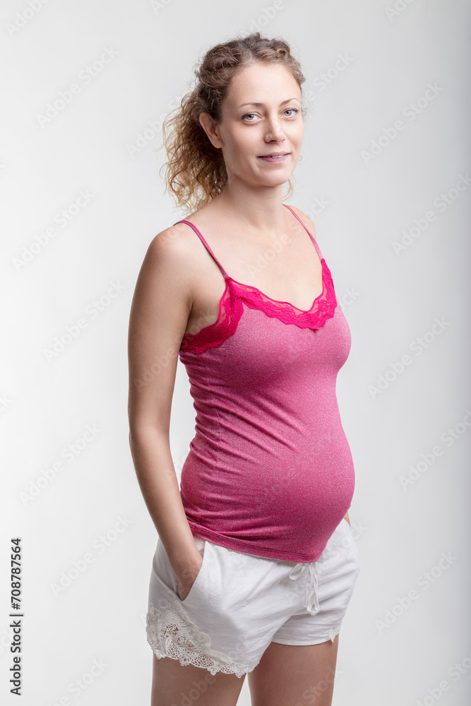 Expectant lady in pink exudes maternal glow Expectant lady in pink exudes maternal glow