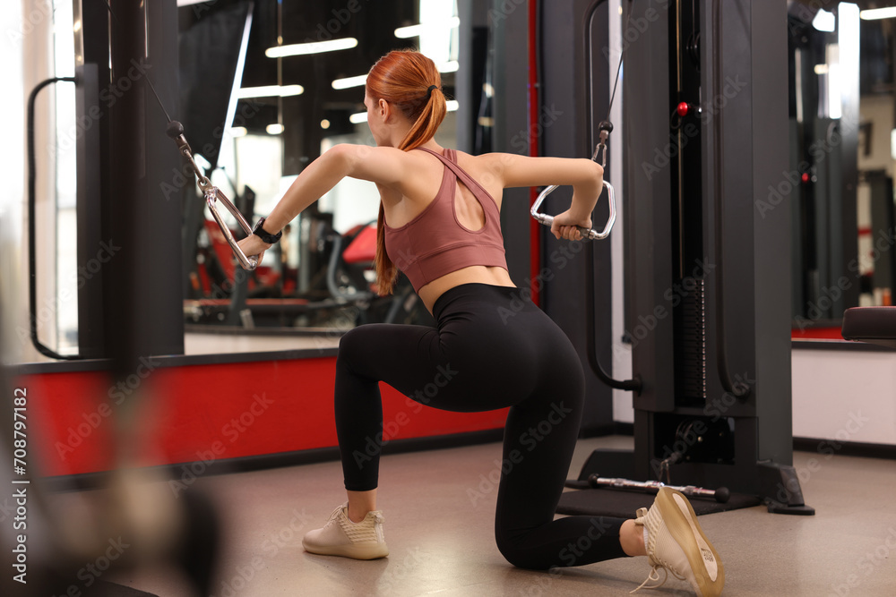 Woman training in modern gym, back view Woman training in modern gym, back view
