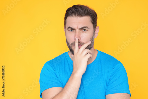 Portrait of thinking man with confused puzzled face on studio isolated background. Man thinking, pensive expression, thoughtful face. Doubt concept. Serious expression, doubting and choice.
