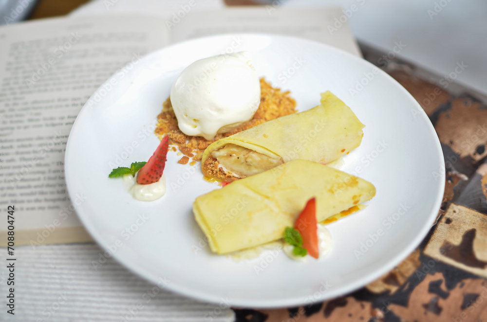 Closeup of banana strudel with ice cream on a white plate Closeup of banana strudel with ice cream on a white plate