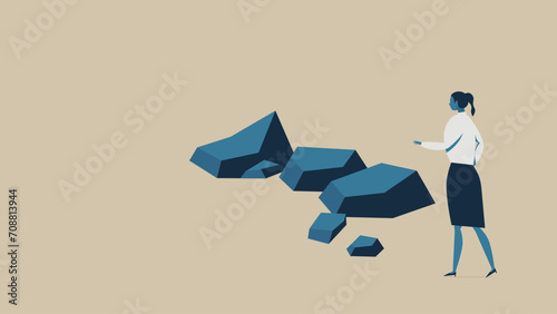 A business woman runs into an obstacle. There are several rocks in front of her.