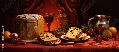 Holiday Panettone with raisins and dried fruits on a red tabletop  adorned with champagne and Christmas decorations  offering a warm and cozy seasonal ambiance.