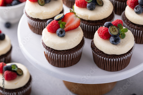 Chocolate cupcakes with vanilla frosting and fresh berries